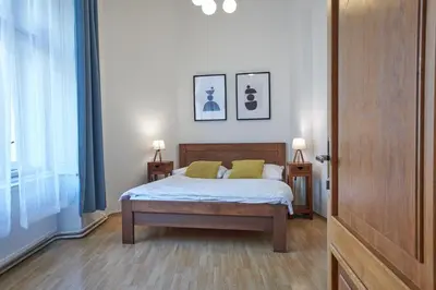 a bedroom with a bed and two pictures on the wall at Narodni - Old Town Residence in Prague