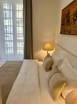 a bedroom with a large white bed with a lamp at CITY CENTRUM CHARMING apartment in Prague