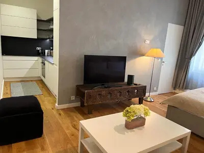 a living room with a tv and a table at CITY CENTRUM CHARMING apartment in Prague