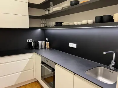 a kitchen with white cabinets and a sink at CITY CENTRUM CHARMING apartment in Prague