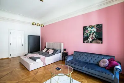 a living room with two beds and a couch at LuxePair Suites Near Prague Castle in Prague