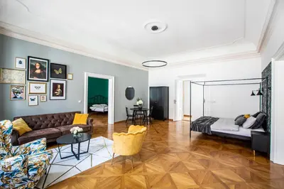 a living room with a couch and a table at LuxePair Suites Near Prague Castle in Prague