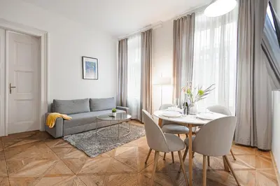 a living room with a couch and a table at Exclusive apartment near Kafka's head in Prague