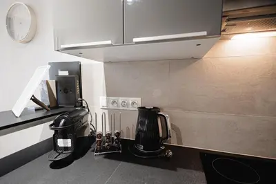 a kitchen with a coffee maker on a counter at Exclusive apartment near Kafka's head in Prague