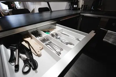 a white drawer in a counter with utensils at Exclusive apartment near Kafka's head in Prague