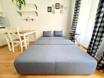 a large bed in a room with a table at Centrum Bohemia Apartment in Prague
