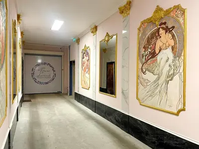 a hallway with paintings on the walls at Centrum Bohemia Apartment in Prague
