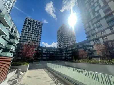 a view of a building with the sun in the sky at Centrum Park Studio in Prague
