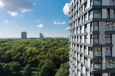 a tall building with trees in front of it at Centrum Park Studio in Prague
