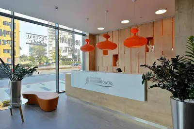 a restaurant with orange pendant lights and a counter at Centrum Park Studio in Prague