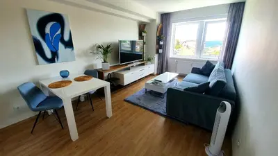 a living room with a couch and a table and a tv at LUXURY APARTMENT VBLOKU in Prague
