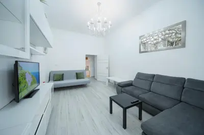 a living room with a couch and a tv at Opletal Apartment Prague in Prague