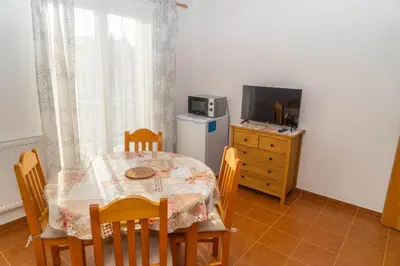 a dining room with a table and chairs and a television at Apartmán Tereza in Poděbrady