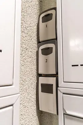 a kitchen with white cabinets with two toasters on the wall at Brand new studio apartment #21 with free secure parking in the center in Prague