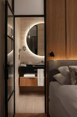 a bedroom with a sink and a bed with a mirror at Soukenicka Apartments Old Town Prague in Prague