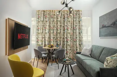 a living room with a couch and a table with chairs at Soukenicka Apartments Old Town Prague in Prague