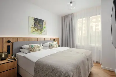 a bedroom with a large bed and a window at Soukenicka Apartments Old Town Prague in Prague