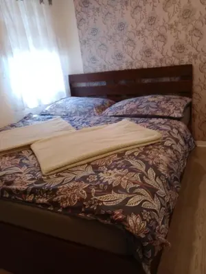 a bed in a bedroom with a blanket on it at Apartmán Marie in Litoměřice