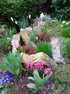 a garden with colorful flowers and rocks at Apartmán Marie in Litoměřice