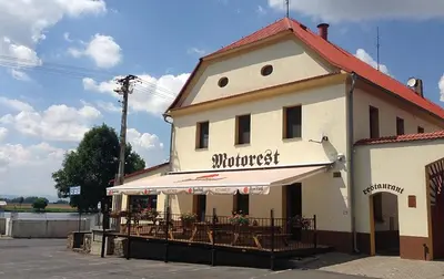 a building with a restaurant with tables and chairs at Apartmán Marie in Litoměřice