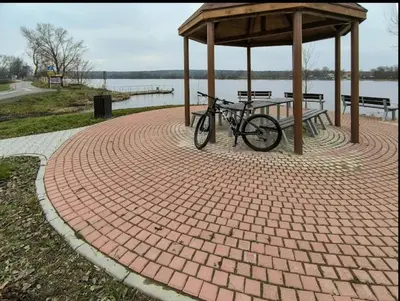 a bike parked under a gazebo next to the water at Apartmán Marie in Litoměřice