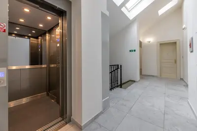 a hallway with a glass door in a building at Luxurious, charming studio perfect for couples in Prague