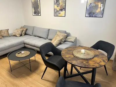 a living room with two tables and a couch at Apartmán Panenská in Prague