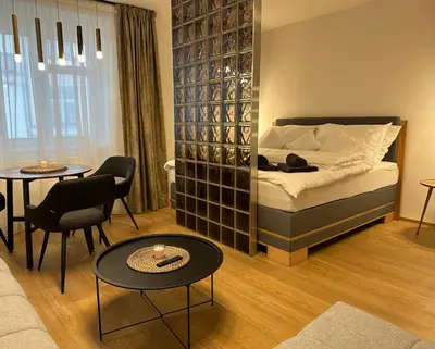 a bedroom with a bed and a table and chairs at Apartmán Panenská in Prague