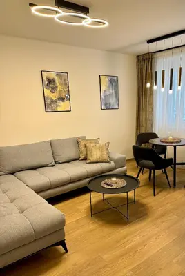 a living room with a couch and a table at Apartmán Panenská in Prague