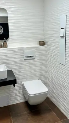 a white bathroom with a toilet and a sink at Apartmán Panenská in Prague