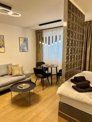 a living room with a couch and a table at Apartmán Panenská in Prague