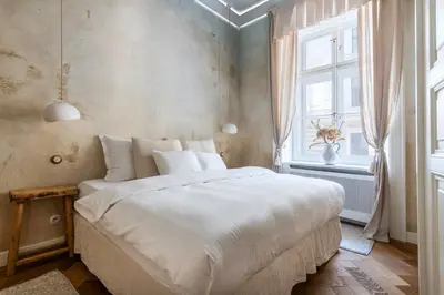 a bedroom with a large white bed and a window at Wabi Sabi Nest w/ Garage in Prague