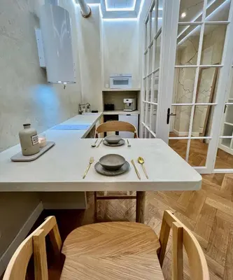 a kitchen with a table with chairs and a counter top at Wabi Sabi Nest w/ Garage in Prague