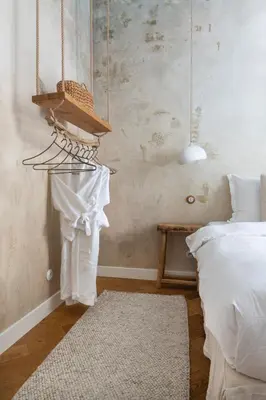 a bedroom with a bed and a shelf with clothes at Wabi Sabi Nest w/ Garage in Prague