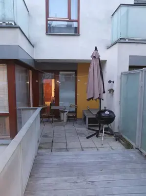 a patio with an umbrella and a table and chairs at AuriApartments Karlín 2KK s terasou a parkováním in Prague