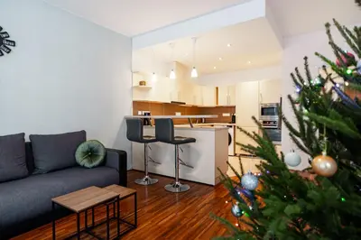 a living room with a christmas tree and a couch at AuriApartments Karlín 2KK s terasou a parkováním in Prague
