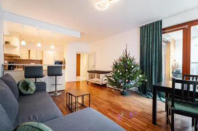 a living room with a christmas tree in it at AuriApartments Karlín 2KK s terasou a parkováním in Prague