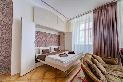 a hotel room with a bed and a window at Extraordinary Prague Apartment in Prague